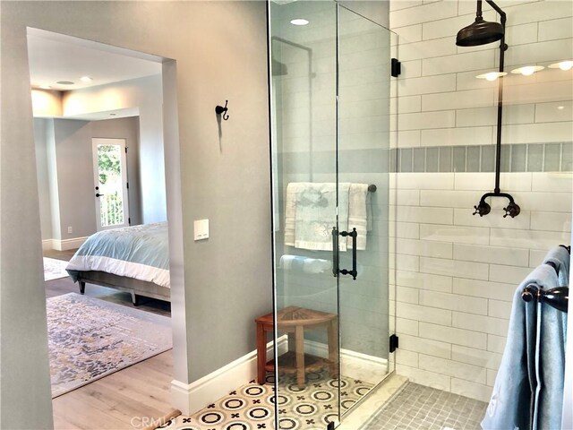 bathroom with hardwood / wood-style floors and walk in shower