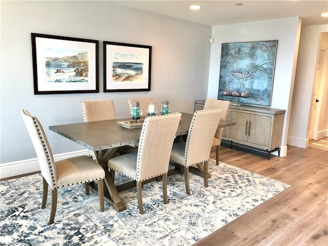 dining space with light hardwood / wood-style floors