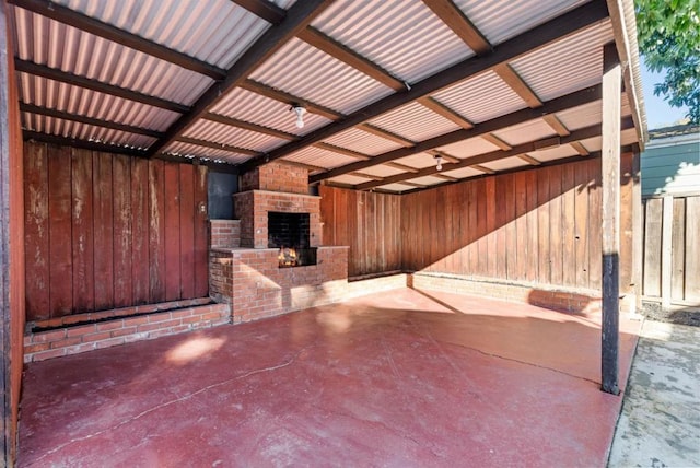 view of patio featuring an outdoor brick fireplace