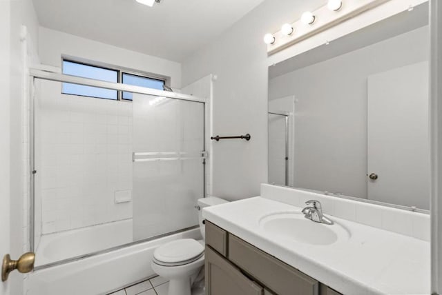 full bathroom with vanity, toilet, combined bath / shower with glass door, and tile patterned flooring