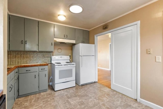 kitchen featuring decorative backsplash, white appliances, and crown molding