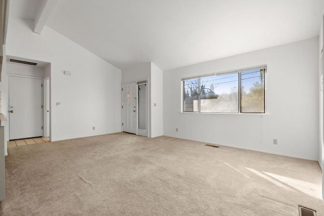 unfurnished bedroom with light carpet, beamed ceiling, and high vaulted ceiling