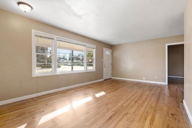 empty room with light hardwood / wood-style flooring