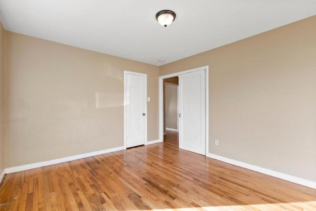 unfurnished room with hardwood / wood-style floors