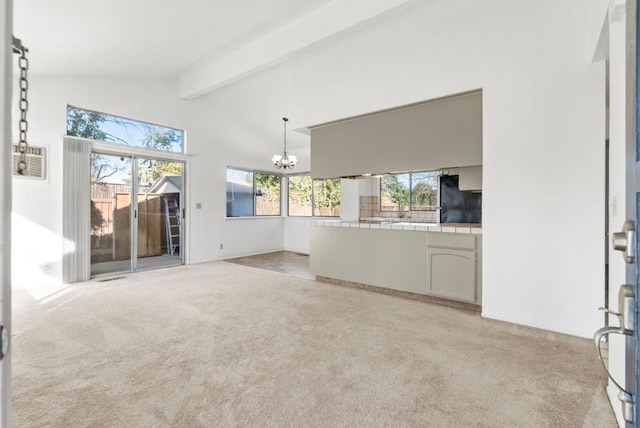 unfurnished living room with high vaulted ceiling, a chandelier, light carpet, and beamed ceiling