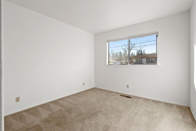 empty room with light colored carpet