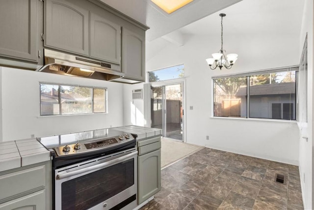 kitchen featuring decorative light fixtures, gray cabinetry, tile countertops, vaulted ceiling with beams, and stainless steel electric range