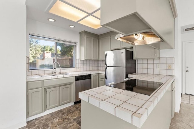 kitchen with decorative backsplash, sink, appliances with stainless steel finishes, and tile countertops