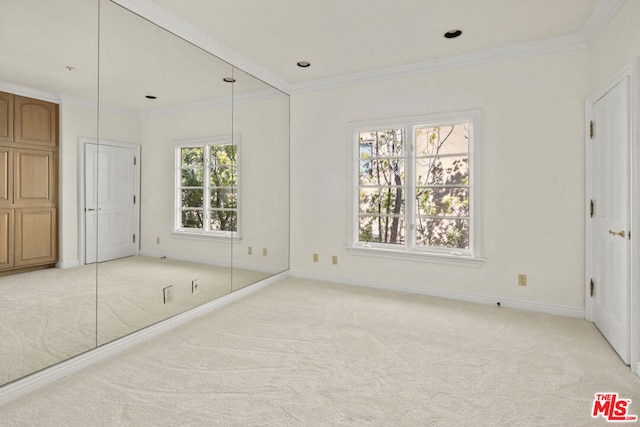 unfurnished bedroom with multiple windows, crown molding, and light colored carpet