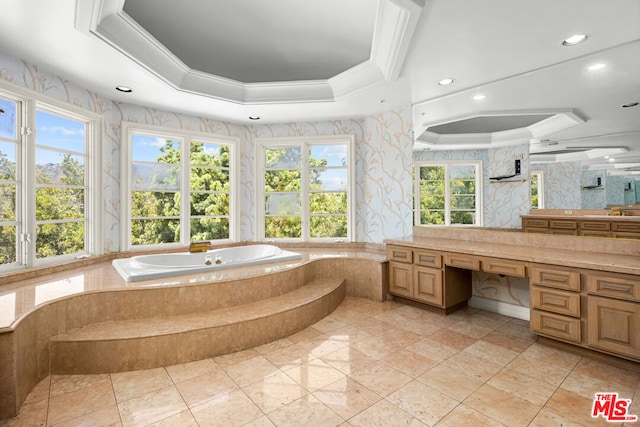 bathroom with tiled tub, crown molding, vanity, and a tray ceiling