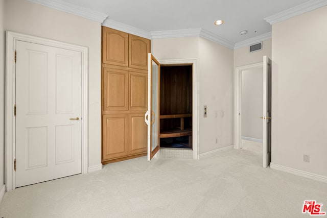 unfurnished bedroom with crown molding and light colored carpet