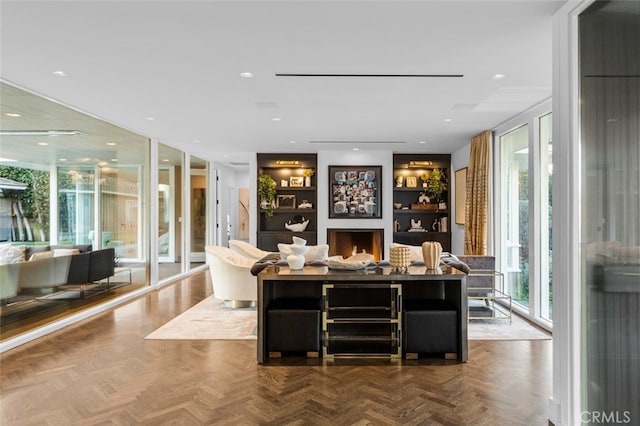 bar featuring built in features, parquet floors, and a healthy amount of sunlight