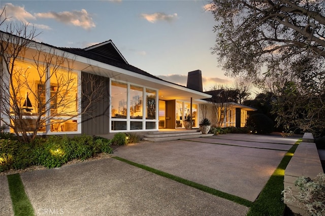 back house at dusk with a patio