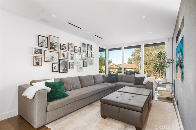 living room featuring light hardwood / wood-style flooring and floor to ceiling windows