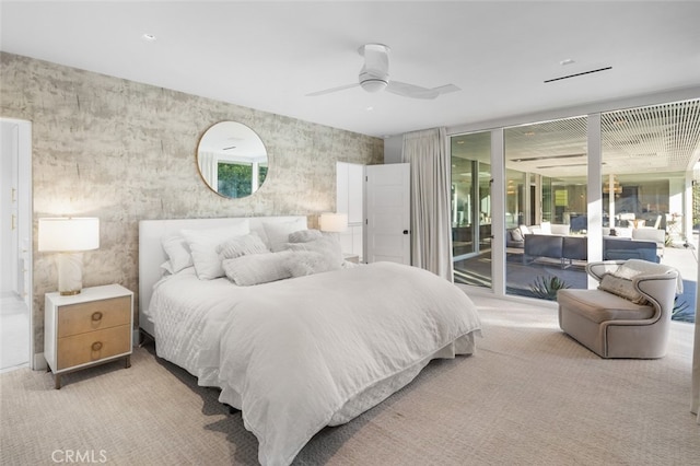 bedroom featuring ceiling fan, light carpet, access to outside, and floor to ceiling windows