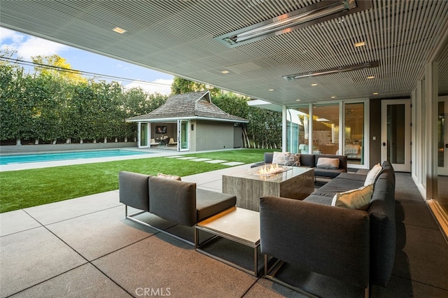 view of patio featuring an outbuilding and an outdoor living space with a fire pit