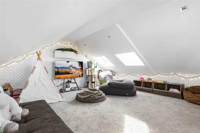 game room with carpet flooring and vaulted ceiling with skylight