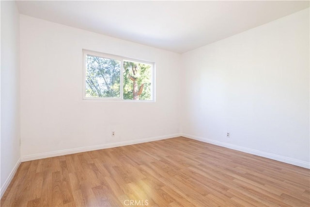 empty room with light hardwood / wood-style floors