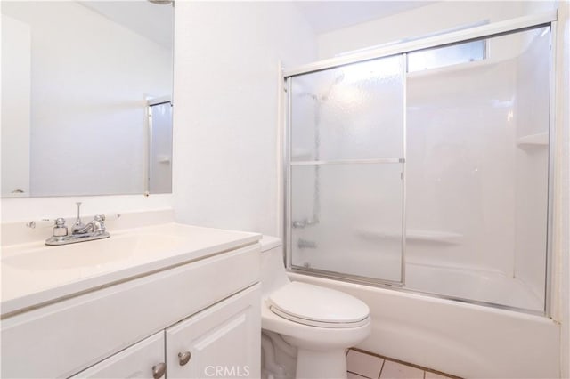 full bathroom with toilet, tile patterned flooring, enclosed tub / shower combo, and vanity