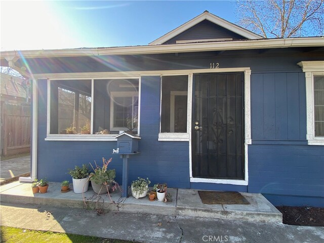 view of exterior entry with fence