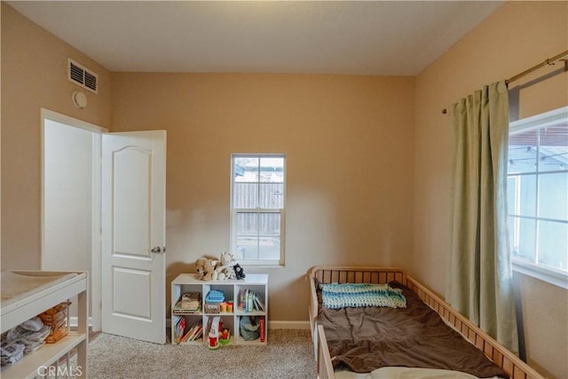 carpeted bedroom with visible vents and baseboards
