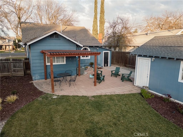 back of house with a storage unit, a pergola, a fenced backyard, an outbuilding, and central air condition unit