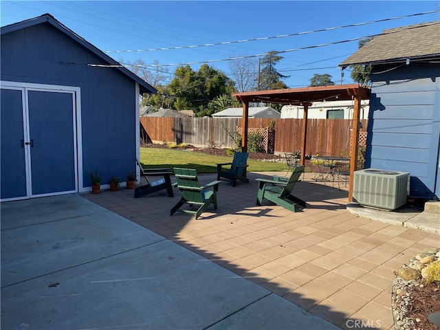 view of patio / terrace with fence, cooling unit, and an outbuilding