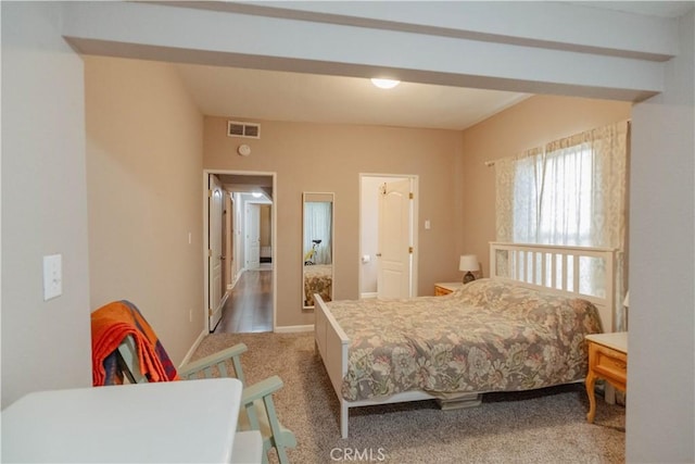 bedroom featuring visible vents and light colored carpet