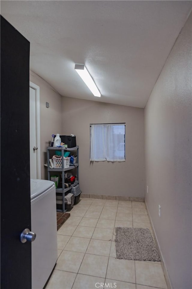 laundry room featuring laundry area, washer / clothes dryer, and light tile patterned flooring