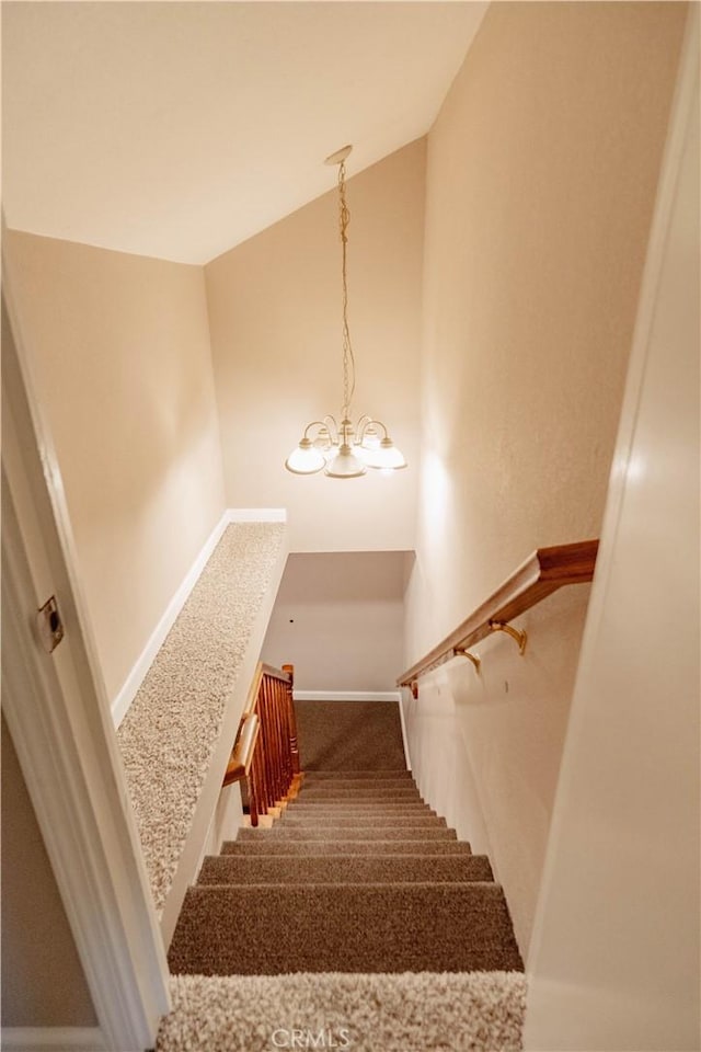 staircase with baseboards and carpet