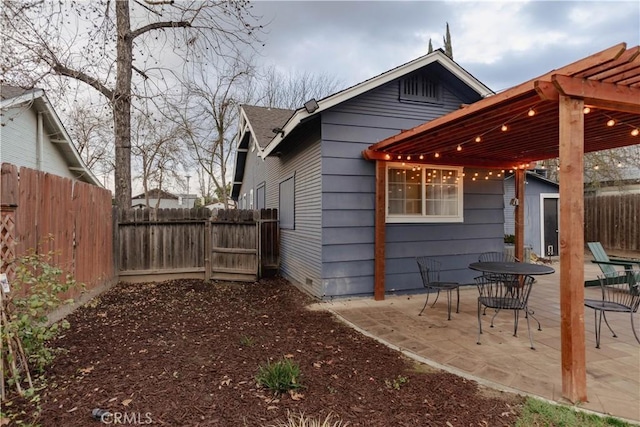 back of property featuring a fenced backyard, a pergola, and a patio