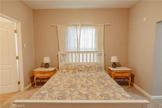bedroom with carpet flooring and baseboards