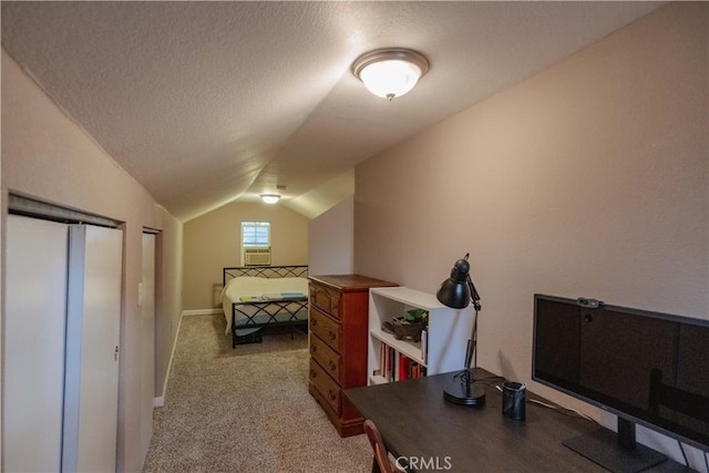 carpeted bedroom featuring vaulted ceiling and a textured ceiling