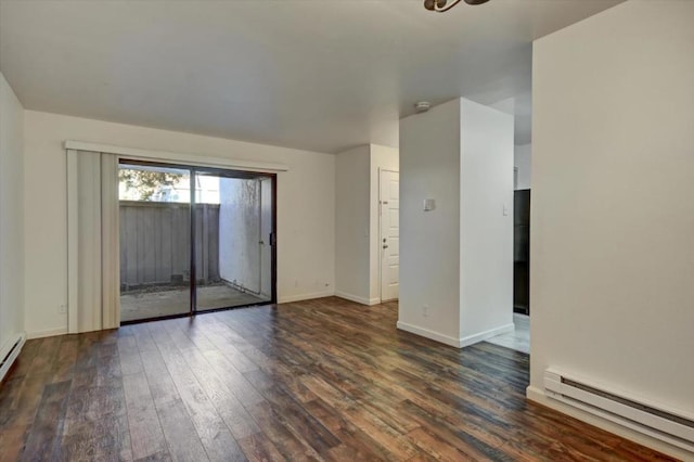 unfurnished room featuring dark hardwood / wood-style floors and a baseboard heating unit