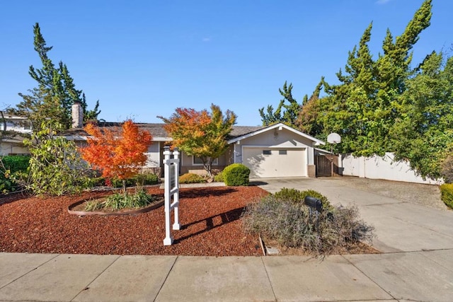 view of property hidden behind natural elements with a garage