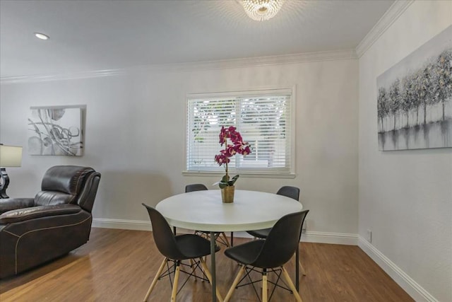 dining area featuring hardwood / wood-style floors and ornamental molding