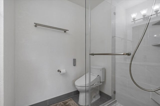 bathroom with toilet, an enclosed shower, and tile patterned flooring