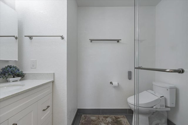 bathroom featuring vanity, toilet, and tile patterned floors