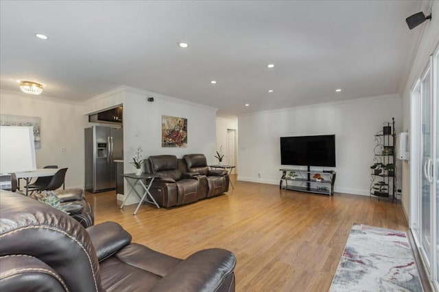 living room with ornamental molding and light wood-type flooring