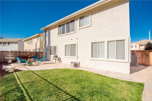 back of house featuring a yard, a patio, and central air condition unit