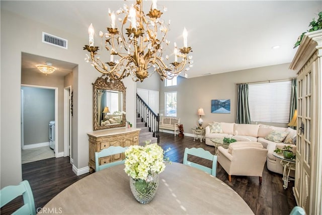 dining room with dark wood-type flooring and an inviting chandelier