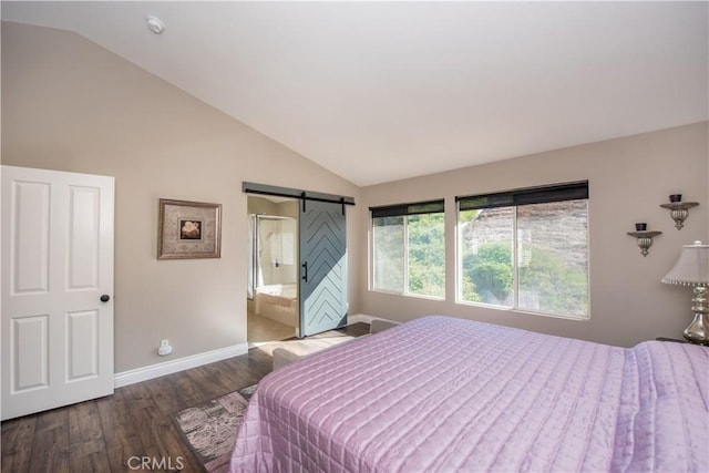 bedroom with hardwood / wood-style floors, ensuite bath, lofted ceiling, and a barn door