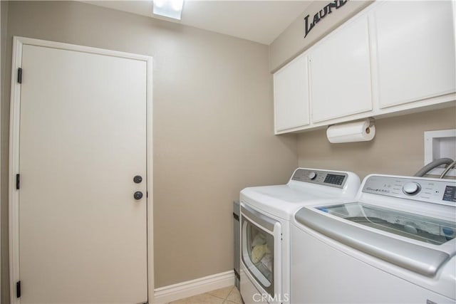 laundry area featuring light tile patterned floors, cabinets, and independent washer and dryer