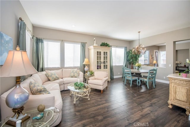 living room featuring dark hardwood / wood-style floors and a notable chandelier