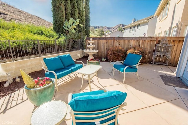 view of patio with a mountain view and an outdoor hangout area