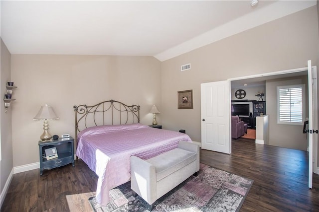 bedroom featuring dark hardwood / wood-style flooring and vaulted ceiling