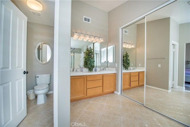 bathroom featuring tile patterned floors, toilet, and vanity