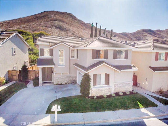 view of front of house featuring a garage and a mountain view