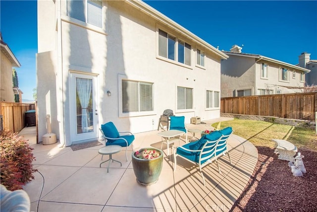 rear view of property featuring a patio