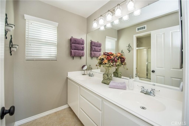 bathroom with vanity, an enclosed shower, and tile patterned flooring